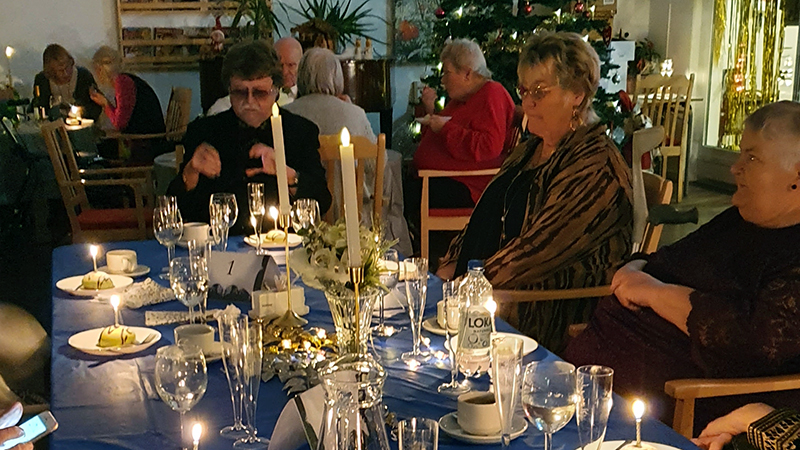 Finklädda människor vid findukat bord