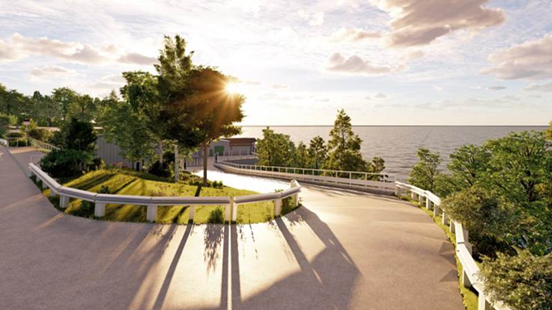 Visionsbild över avloppsreningsverket sett från Smådalarövägen. Avloppsreningsbyggnad liggandes vid strandkanten.