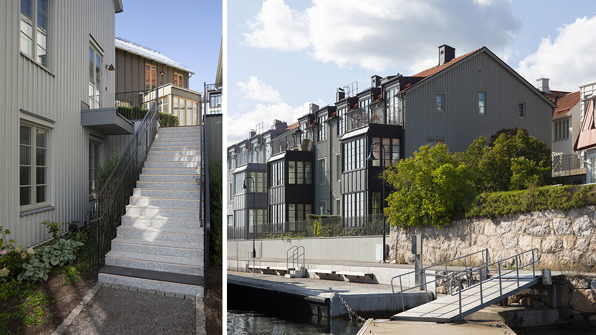 Gråa husfasader med glasverandor samt en trappa i cement