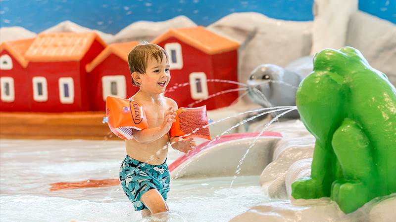 Plasken är Torvalla simhalls barnpool. Barn med armpuffar som leker i plasbassängen i simhallen.